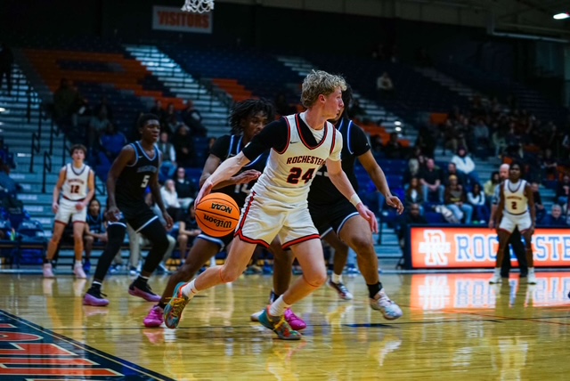 Player #24 Jack Melton dribbles to try and pass to a teammate while other Macarthur players defend against him. 